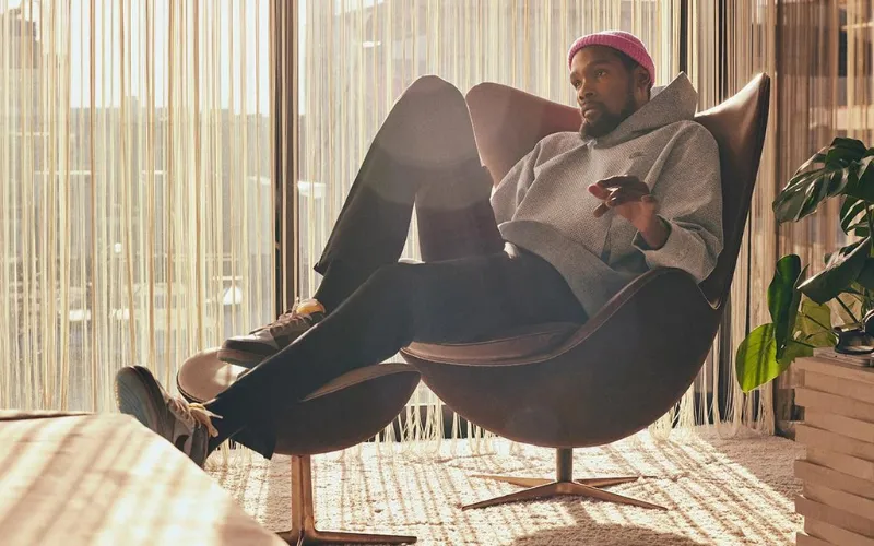 Kevin Durant in a chair with pink beanie on